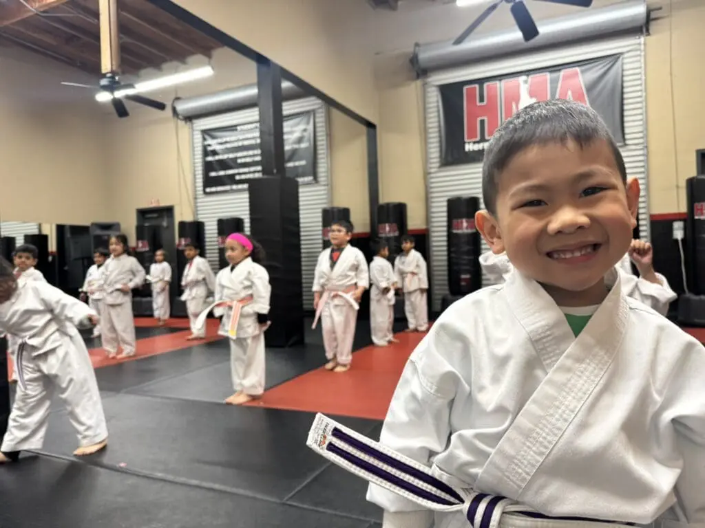 Smiling preschool karate student in beginner martial arts class in Union City