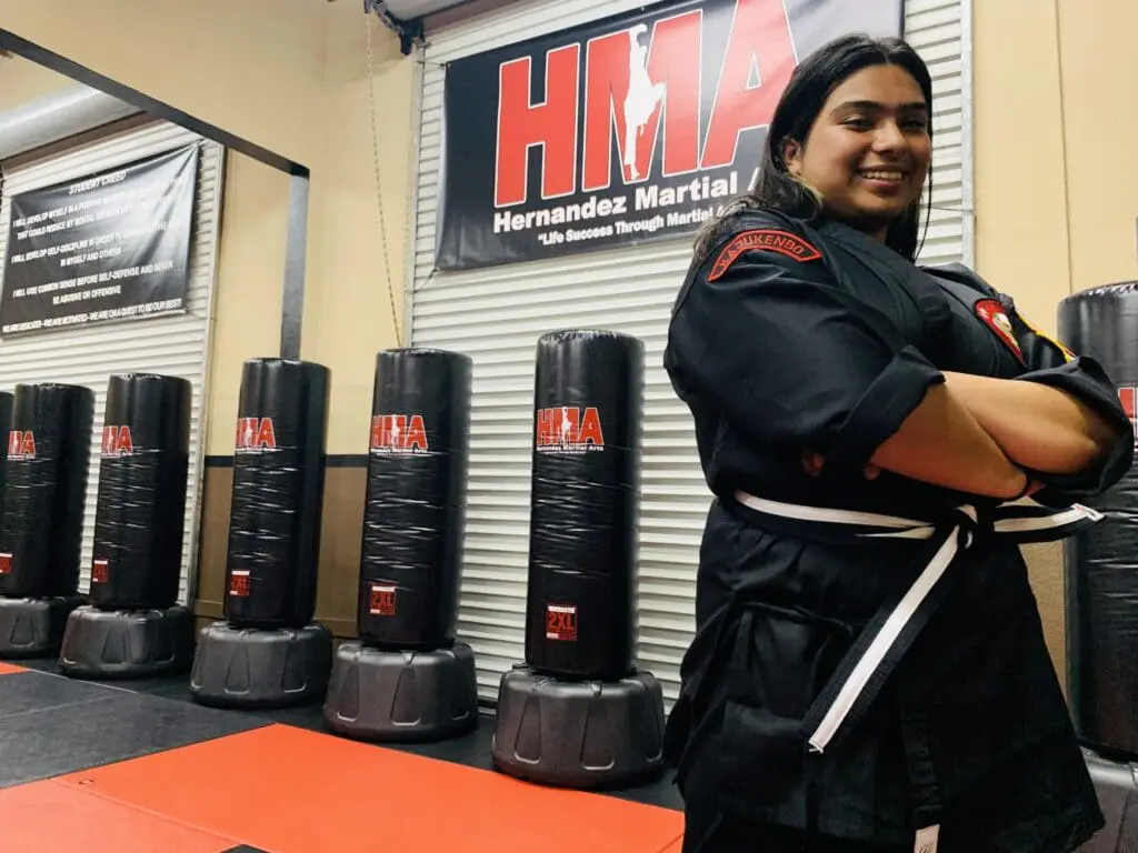 Teen martial arts students practicing focus, discipline, and self-control in class